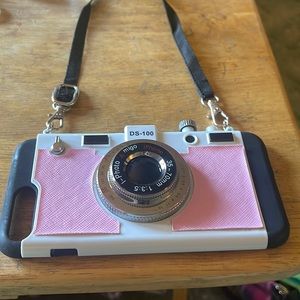 Pink iPhone 7 Plus case with removable lanyard. Looks like a camera
